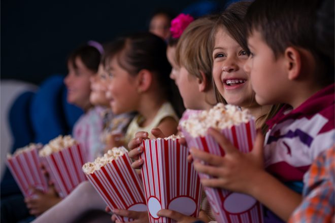 Kids eating popcorn in the movie theater